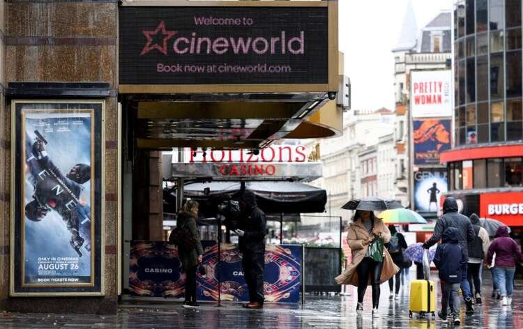People walking past a Cineworld cinema in Leicester Square, London, reflecting challenges for the cinema industry - Global Banking & Finance Review