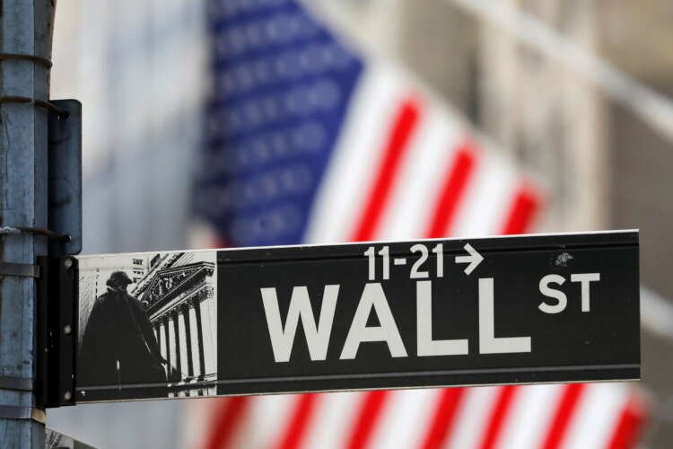 Wall Street sign outside the New York Stock Exchange amidst market fluctuations - Global Banking & Finance Review