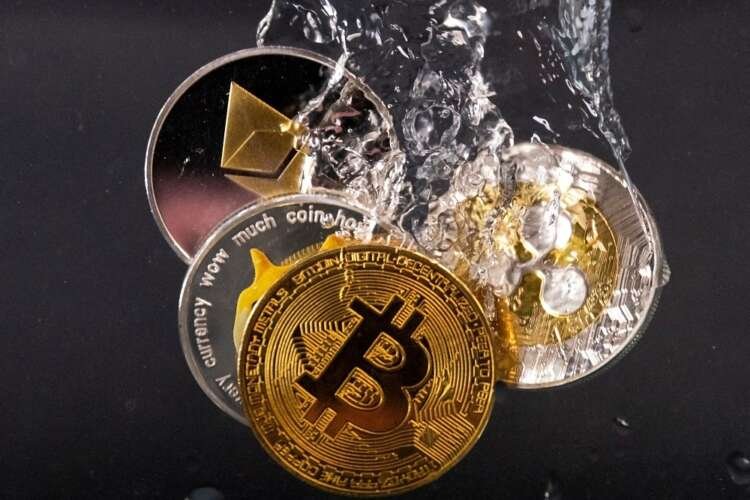 Souvenir tokens representing Bitcoin and Ethereum plunge into water - Global Banking & Finance Review