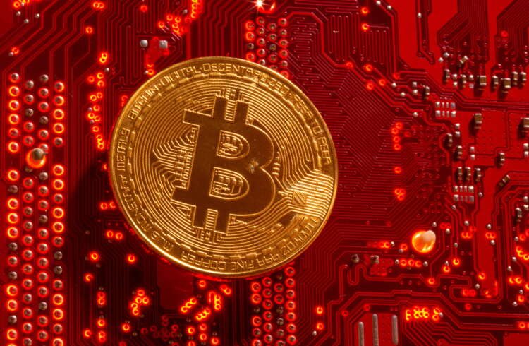 Bitcoin symbol on a PC motherboard representing cryptocurrency investment trends - Global Banking & Finance Review