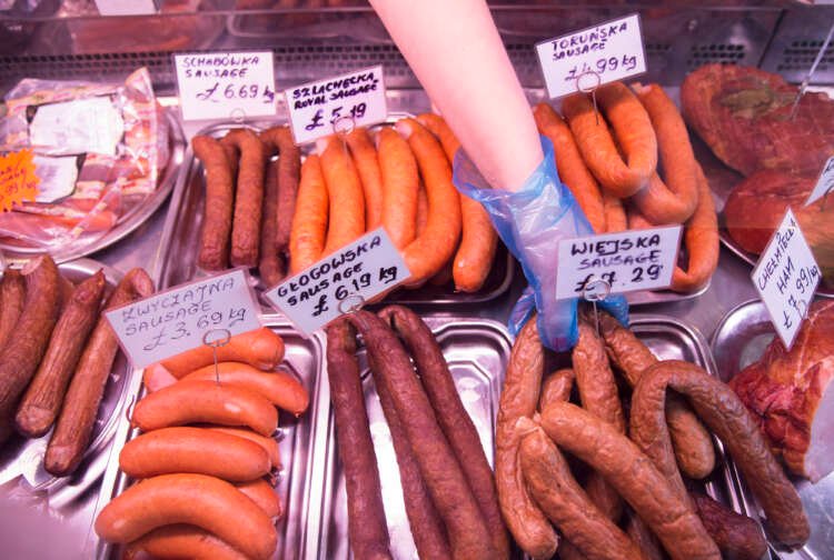 Worker at Polish delicatessen in Britain, highlighting EU-UK sausage war ceasefire - Global Banking & Finance Review