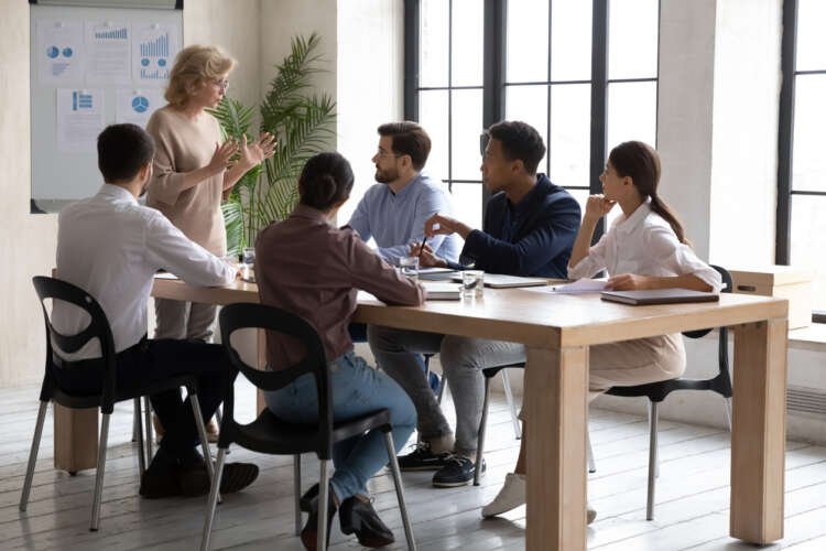 Businesswoman presenting a mid-year review strategy for economic challenges - Global Banking & Finance Review