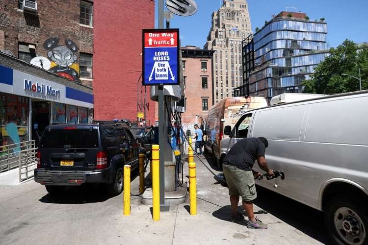 People refueling vehicles at a gas station amid rising oil prices - Global Banking & Finance Review