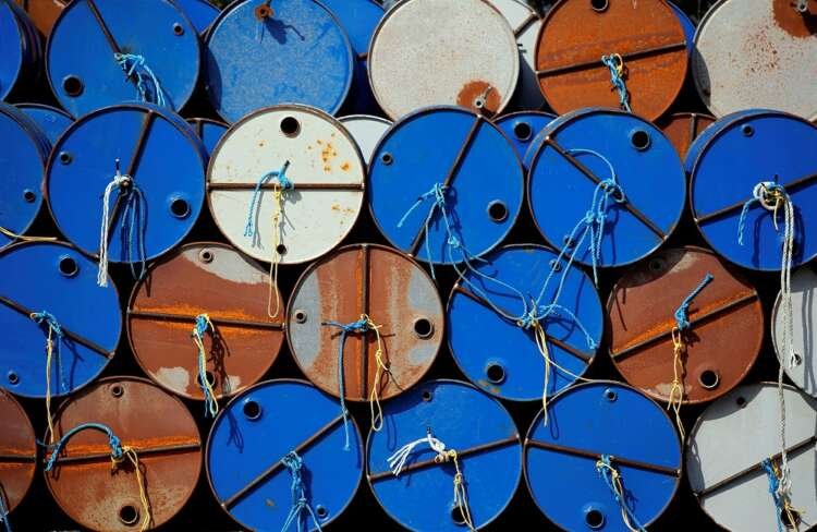 Oil barrels at a drilling site reflecting the impact of OPEC+ output on prices - Global Banking & Finance Review