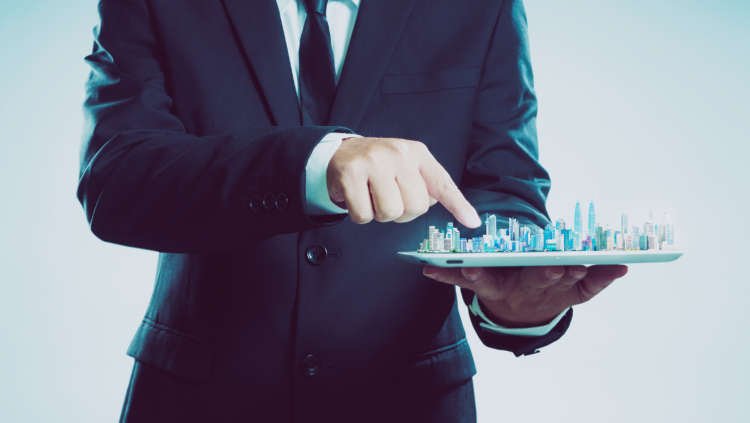 graphicstock-success-businessman-using-digital-tablet-show-the-city-skyline-on-virtual-screen-smart-and-modern-city-concept_Sdgusowlox