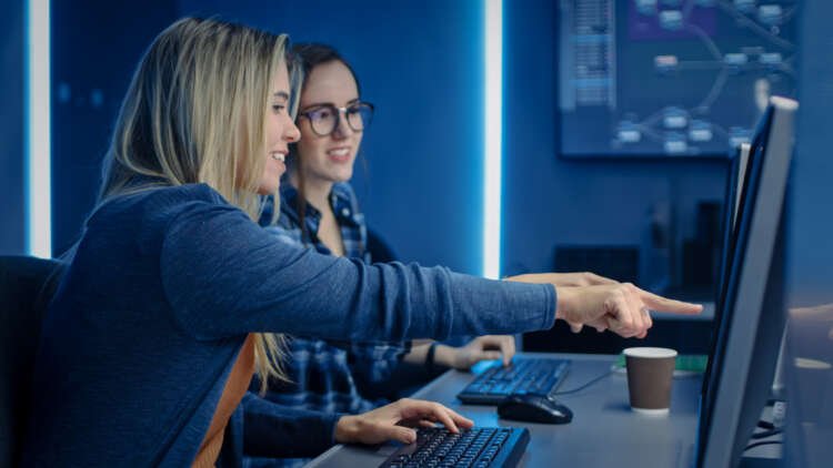 Two female IT professionals collaborating on cybersecurity solutions - Global Banking & Finance Review