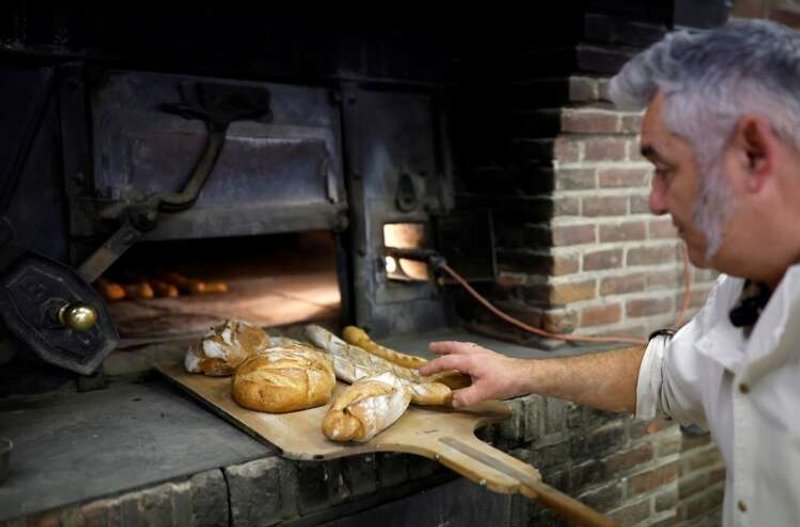Image for Back to basics: wood-fired oven shields French baker from soaring energy costs