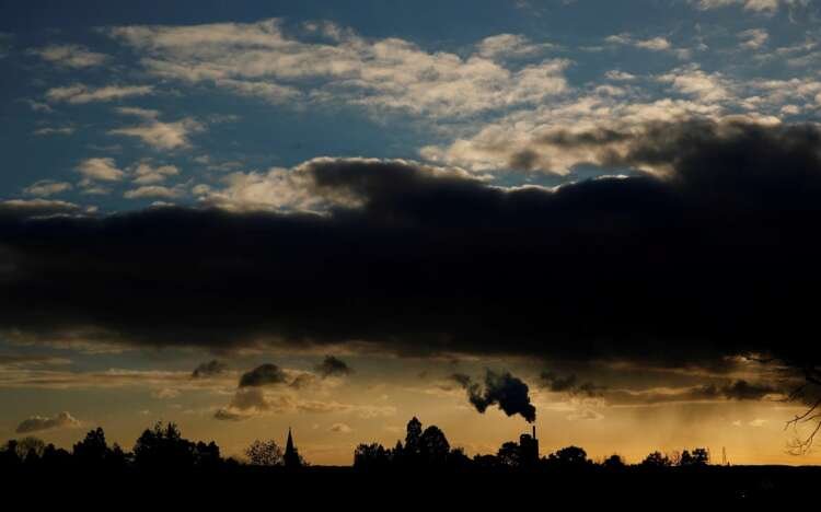 Factory smoke at sunset symbolizes challenges in UK manufacturing growth - Global Banking & Finance Review
