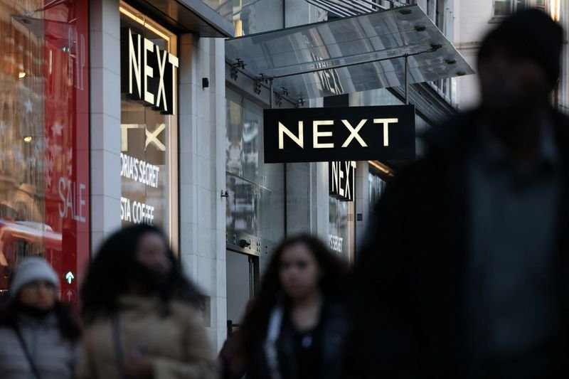 Next clothing retailer's logo with a financial growth chart - Global Banking & Finance Review