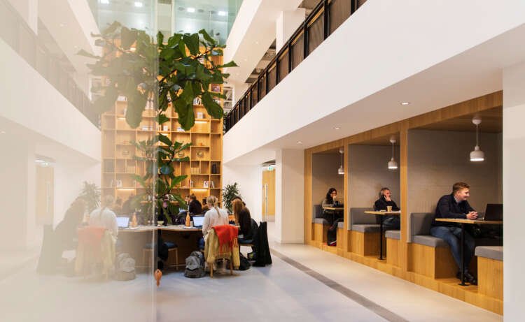 People collaborating in a modern coworking space at an IWG office - Global Banking & Finance Review