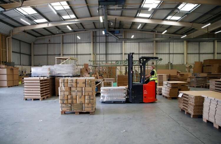 Factory workers amid the COVID-19 pandemic reflecting UK's manufacturing confidence decline - Global Banking & Finance Review