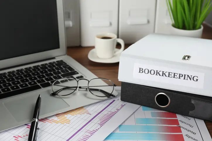 Business professional reviewing financial documents for bookkeeping - Global Banking & Finance Review