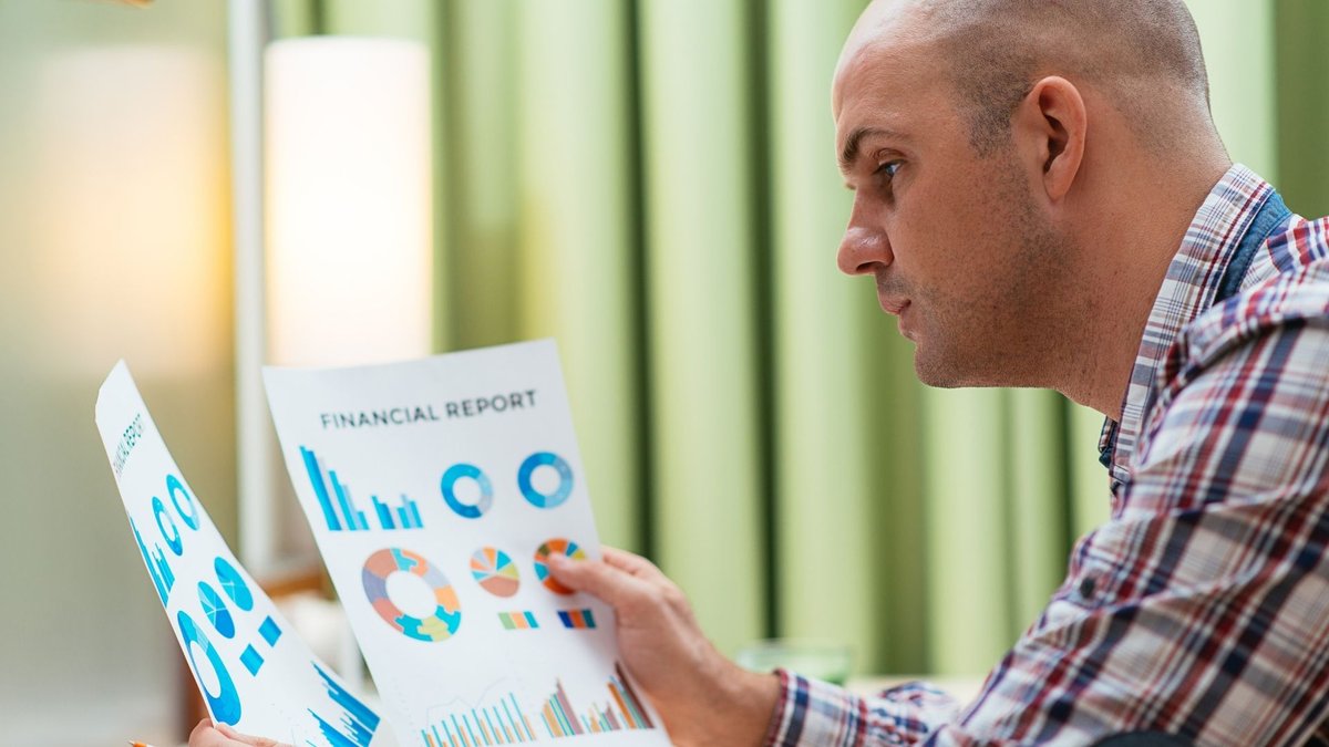 Concerned middle-aged man reflecting on financial stress impacting mental health - Global Banking & Finance Review