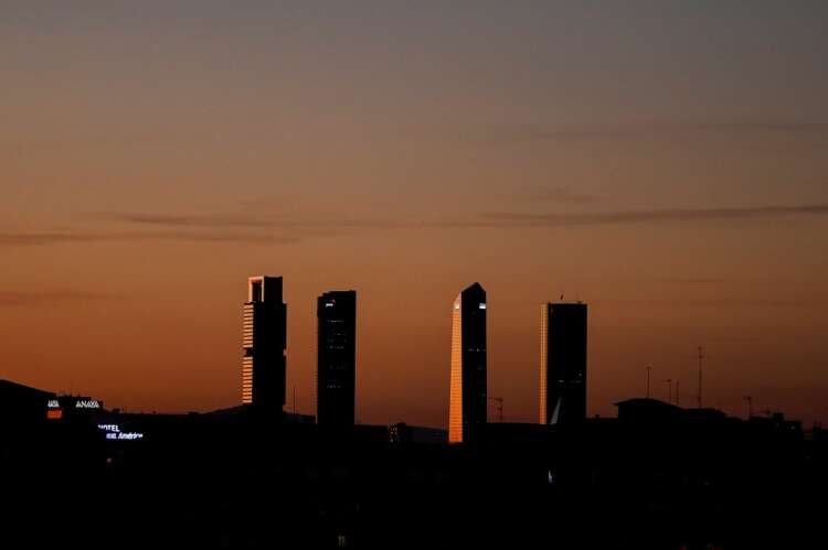 Sunset over Madrid's Four Towers, symbolizing Spain's four-day work week benefits - Global Banking & Finance Review