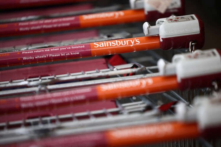 Trolleys stacked in a Sainsbury’s supermarket, highlighting seasonal hiring for Christmas - Global Banking & Finance Review