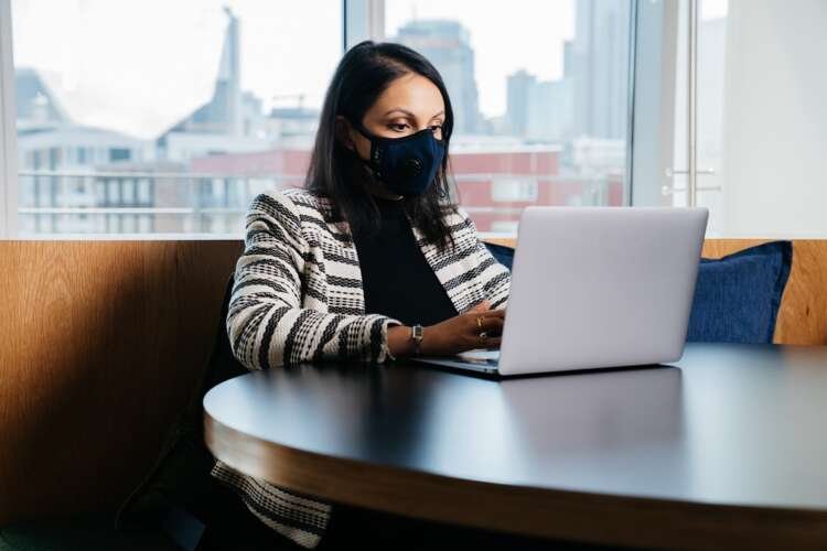 Indian female lawyer working on a computer with face mask, reflecting digital transformation in business - Global Banking & Finance Review