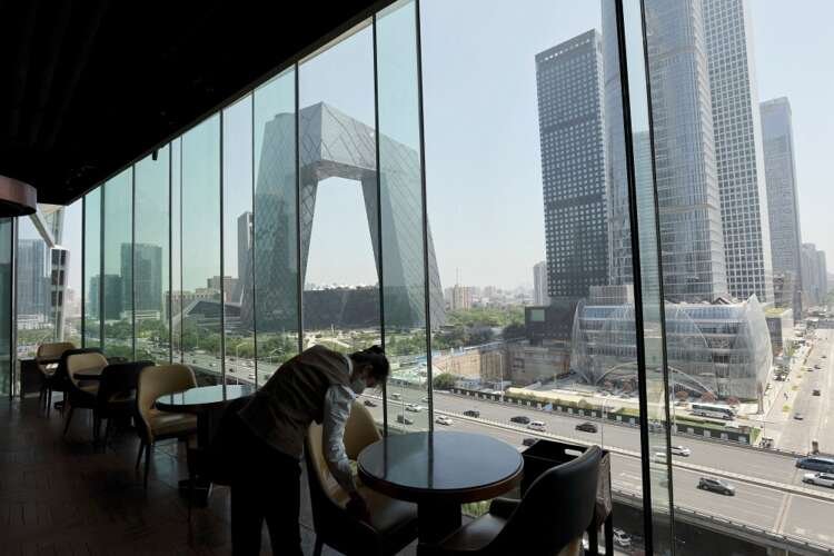 Staff member in Beijing's Central Business District amid COVID-19 consumer lockdown - Global Banking & Finance Review