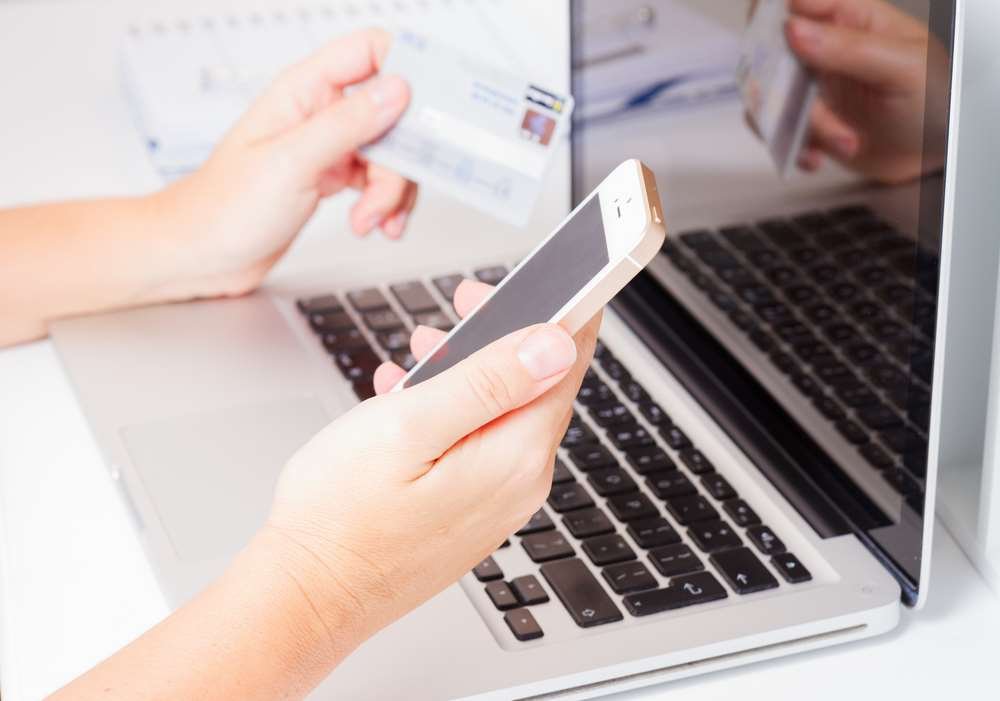 Person using a smartphone with banking app, highlighting security habits - Global Banking & Finance Review