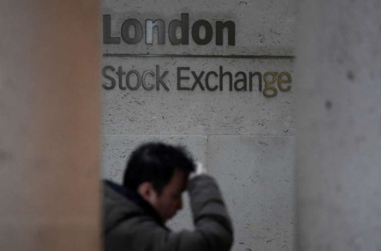 People walking past the London Stock Exchange, reflecting FTSE 100's miners boost - Global Banking & Finance Review