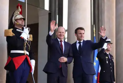 Image for Macron, Scholz plaster over differences with smiles and a handshake