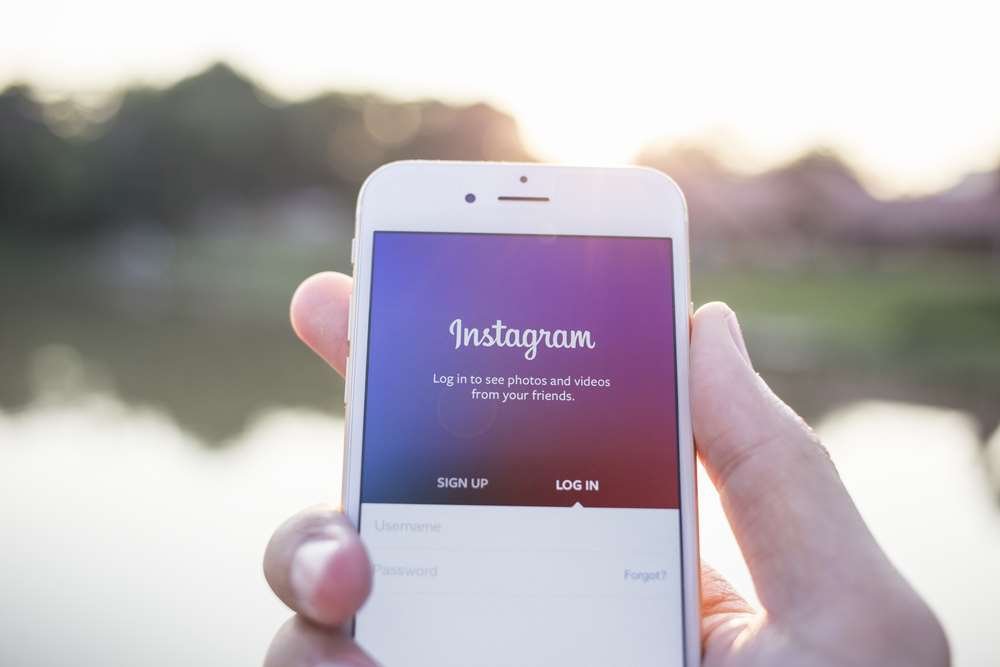 A person strategizing Instagram growth with a smartphone - Global Banking & Finance Review