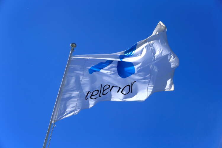 Telenor's logo with a backdrop of Myanmar's flag, highlighting telecom issues - Global Banking & Finance Review