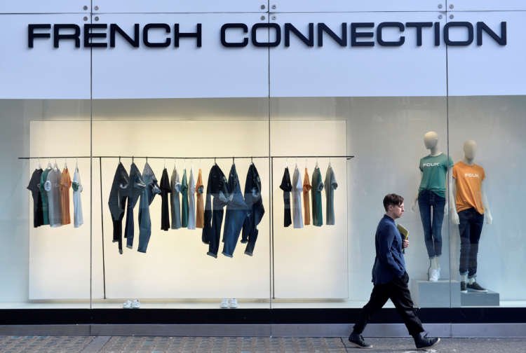 A person walks past a French Connection store, highlighting the UK fashion retailer's challenges - Global Banking & Finance Review