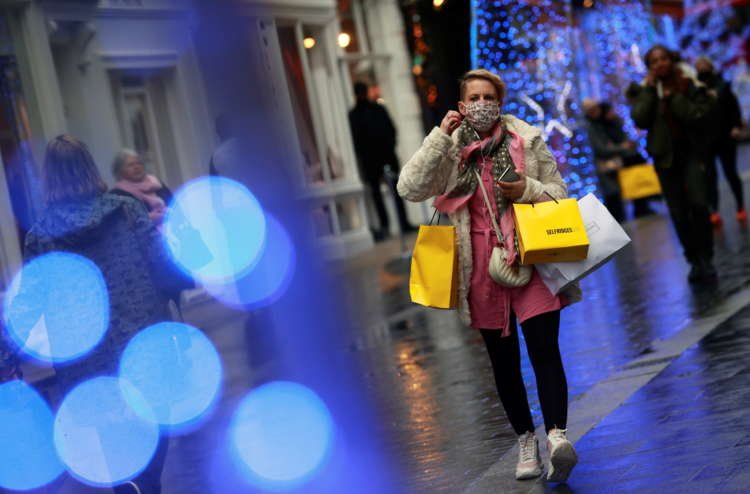 A shopper walks down the street in London