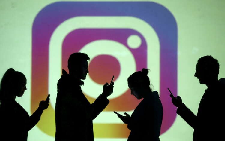 Silhouettes of mobile users with Instagram logo represent digital copyright issues - Global Banking & Finance Review