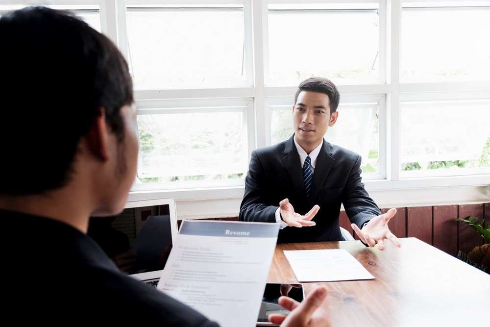 Business professionals discussing interview strategies for job candidates - Global Banking & Finance Review