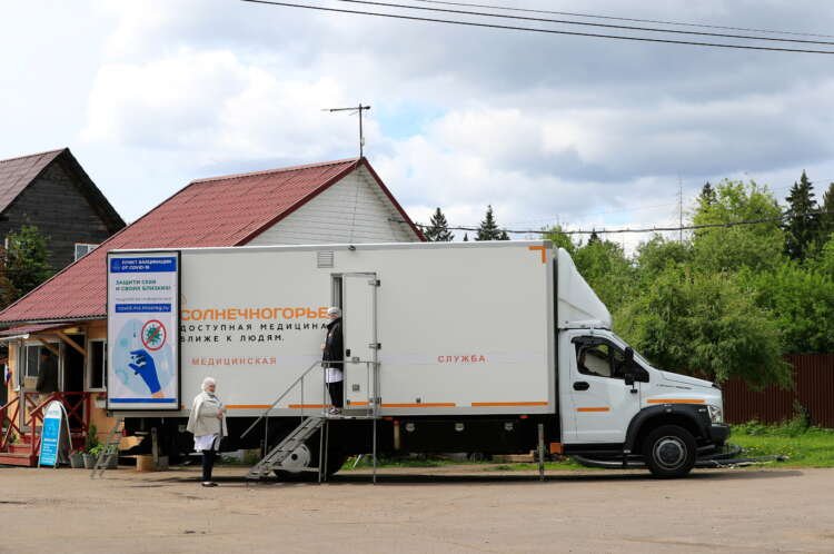Medical workers are seen at a mobile coronavirus disease (COVID-19) vaccination centre in a dacha community in Moscow Region