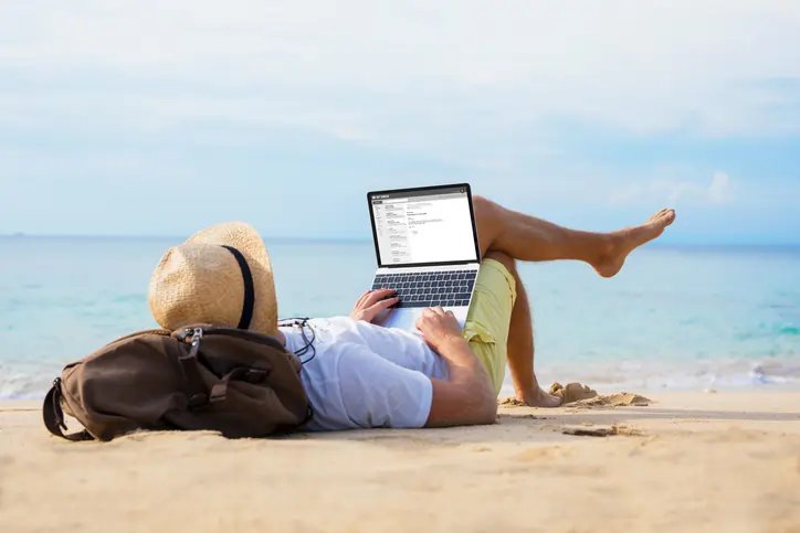 Person contemplating work ideas while relaxing on holiday - Global Banking & Finance Review