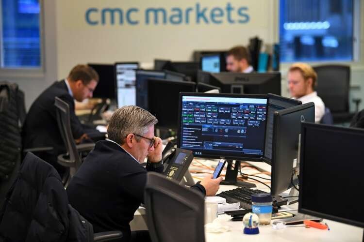 Traders analyze market data at CMC Markets amidst rising volatility - Global Banking & Finance Review