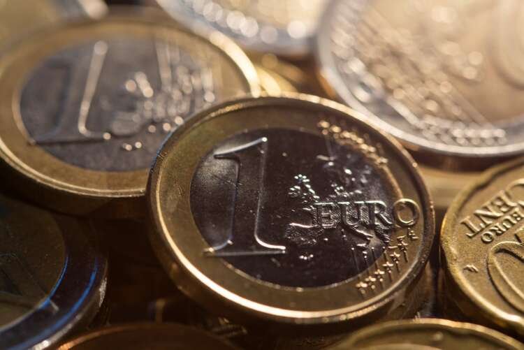 Euro coins with financial charts symbolizing rising bond yields - Global Banking & Finance Review