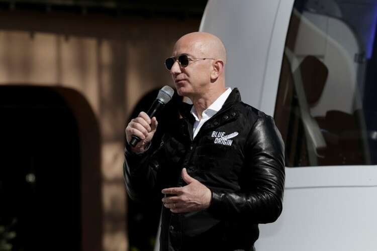 FILE PHOTO: Amazon and Blue Origin founder Jeff Bezos addresses the media about the New Shepard rocket booster and Crew Capsule mockup at the 33rd Space Symposium in Colorado Springs