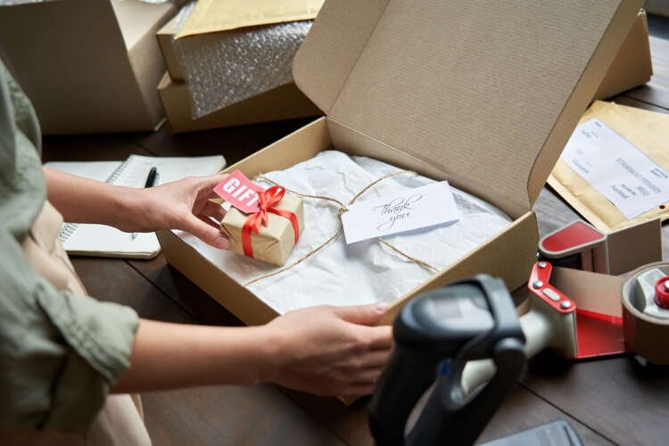 Small business owner preparing a delivery package for customer connectivity - Global Banking & Finance Review