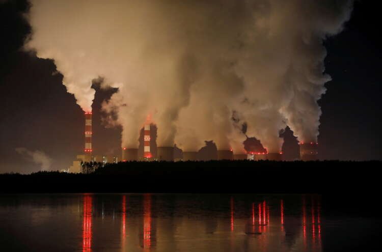 Smoke and steam billows from Belchatow Power Station, symbolizing finance's role in climate action - Global Banking & Finance Review