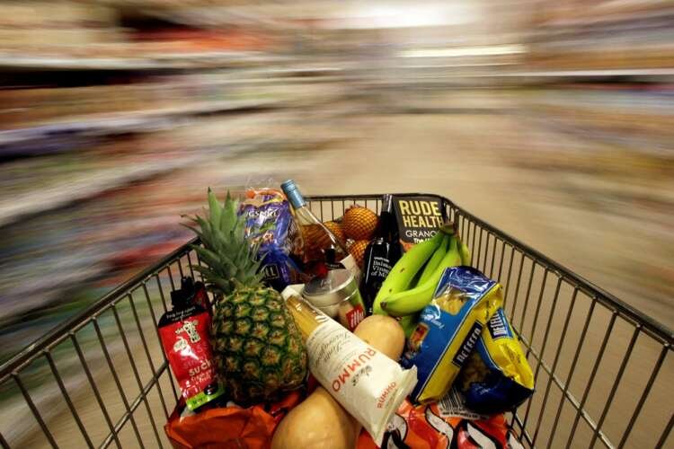 Shopping trolley in a London supermarket showcasing rising prices amidst inflation - Global Banking & Finance Review