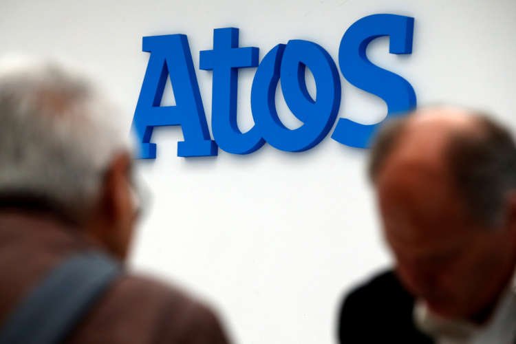 Atos company logo displayed in front of a business presentation - Global Banking & Finance Review