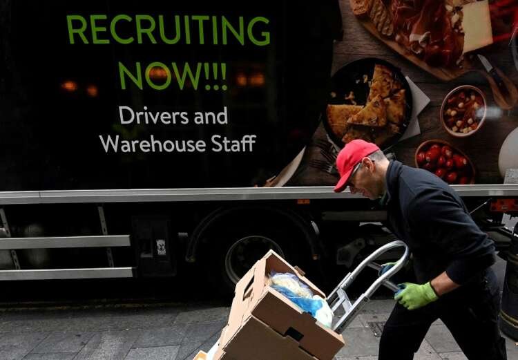 Lorry driver in London advertising job vacancies amidst UK labor shortages - Global Banking & Finance Review