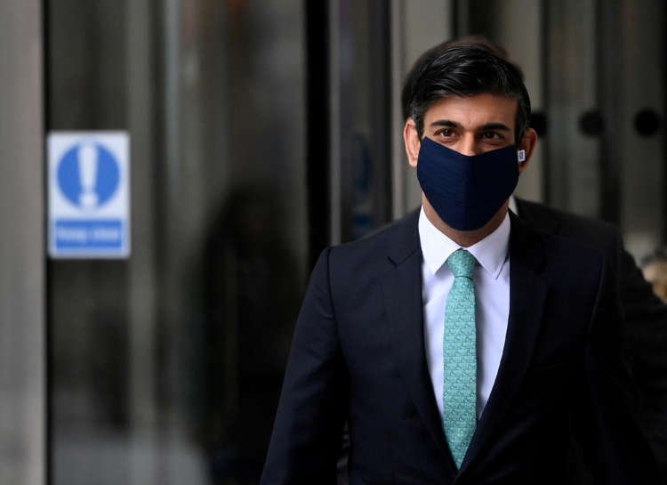 FILE PHOTO: Britain’s Chancellor Sunak leaves after appearing on BBC TV’s The Andrew Marr Show, in London