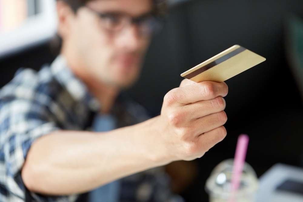 Young adults managing credit cards, highlighting self-control concerns - Global Banking & Finance Review