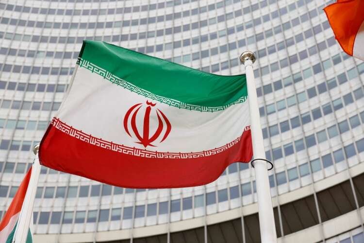 Iranian flag in front of IAEA headquarters highlighting nuclear oversight - Global Banking & Finance Review