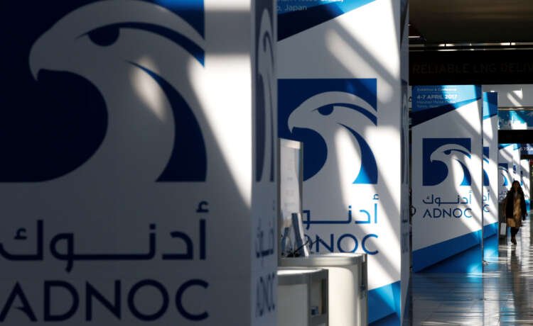 Logos of ADNOC at Gastech, showcasing carbon capture initiatives - Global Banking & Finance Review