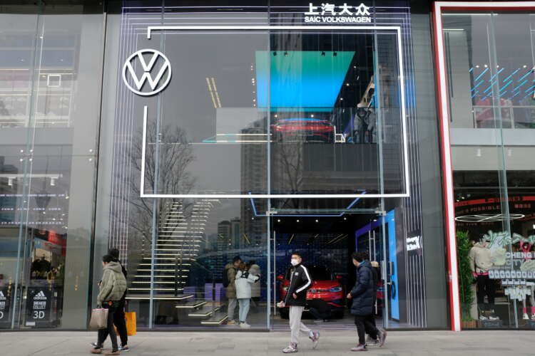 People walking past a Volkswagen ID. Store X showroom in Chengdu, showcasing electric vehicles - Global Banking & Finance Review
