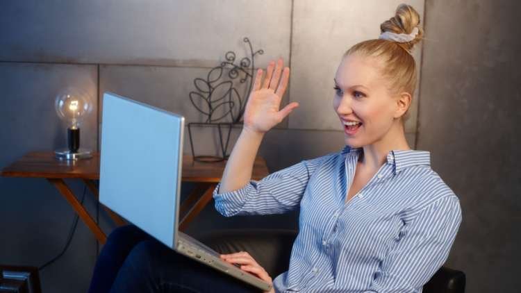 Person engaging in a virtual video call, representing tips for improving webcam quality - Global Banking & Finance Review