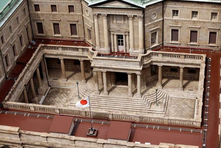 Japanese flag at Bank of Japan headquarters, symbolizing economic policies - Global Banking & Finance Review