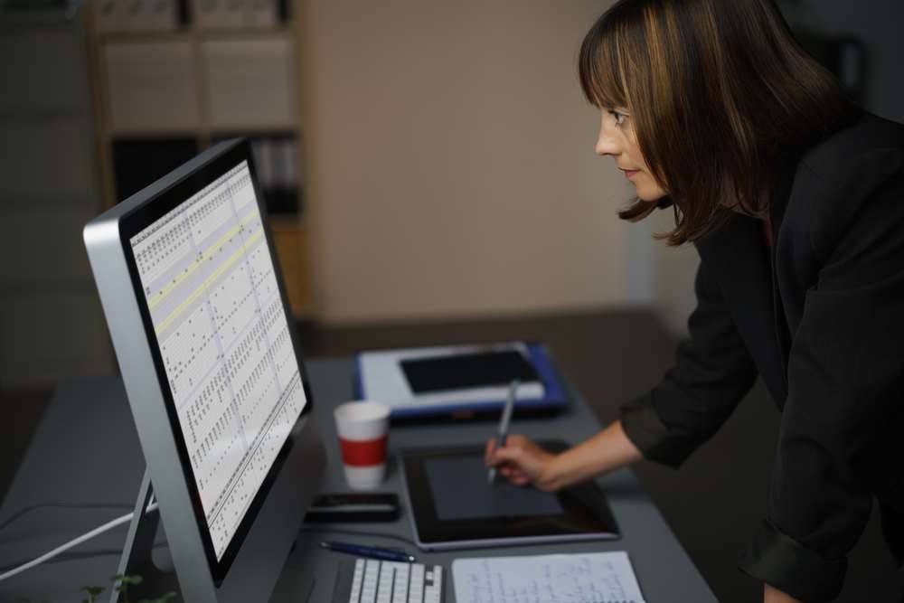 Business professionals discussing outsourcing strategies for SMEs - Global Banking & Finance Review