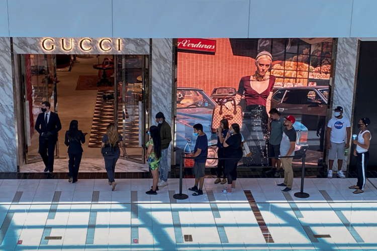 FILE PHOTO: Customers line up to enter a Gucci fashion store at the The Galleria shopping mall after the mall opened during the coronavirus disease (COVID -19) outbreak in Houston