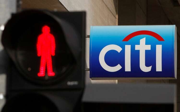 Citibank branch with a traffic light, symbolizing Citigroup's restructuring - Global Banking & Finance Review